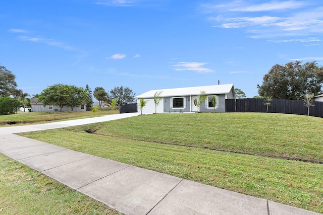 ranch-style home with a front lawn and a garage