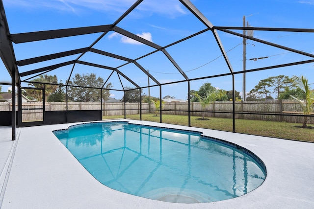 view of swimming pool featuring a lawn, glass enclosure, and a patio