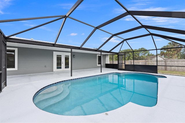 view of pool featuring french doors, a patio, and glass enclosure