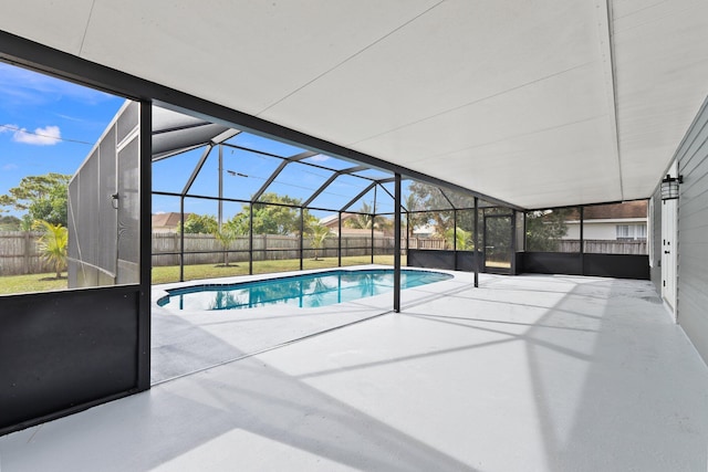 view of swimming pool featuring a patio and a lanai