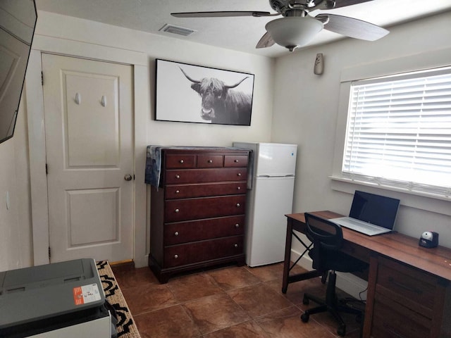 office with dark tile patterned flooring and ceiling fan