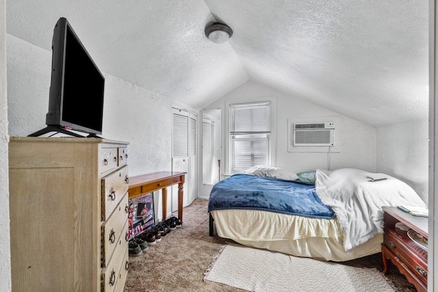 bedroom featuring a textured ceiling, carpet floors, an AC wall unit, and lofted ceiling