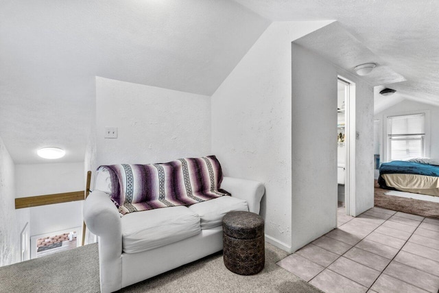 interior space with light tile patterned flooring and vaulted ceiling