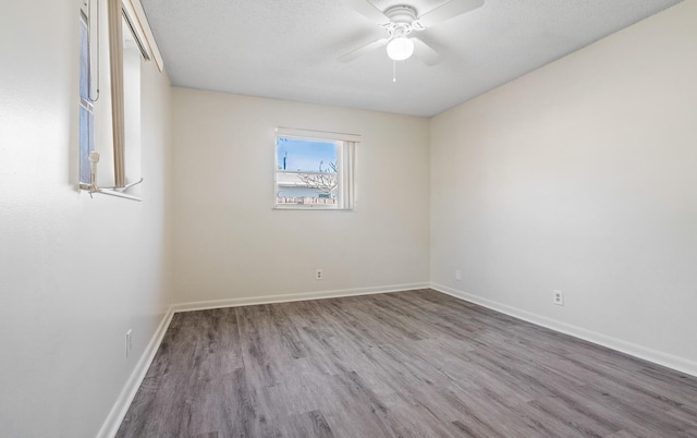 empty room with hardwood / wood-style flooring and ceiling fan