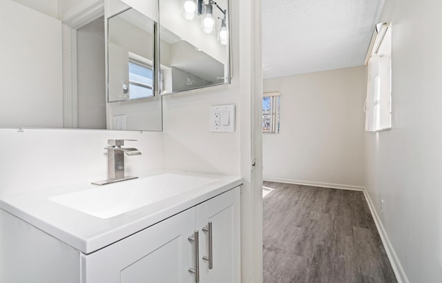 bathroom with vanity, a textured ceiling, and wood-type flooring