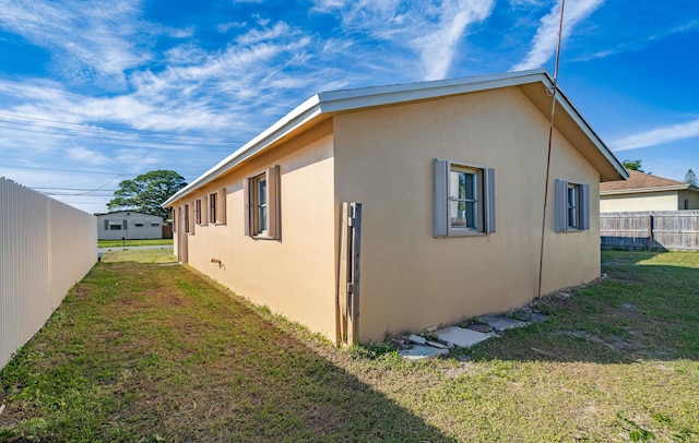 view of side of home with a lawn