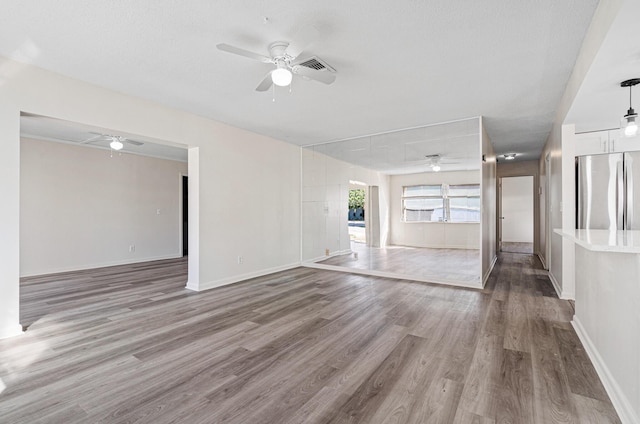 empty room featuring wood-type flooring and ceiling fan