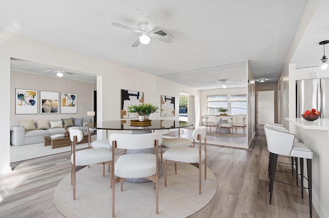 dining space featuring light hardwood / wood-style flooring and ceiling fan