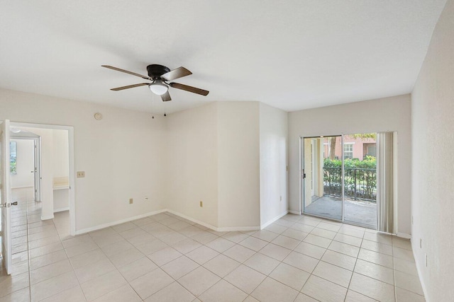 empty room with ceiling fan and light tile patterned floors