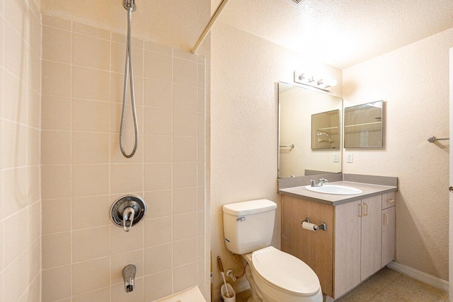 bathroom featuring a tile shower, tile patterned flooring, a textured ceiling, toilet, and vanity