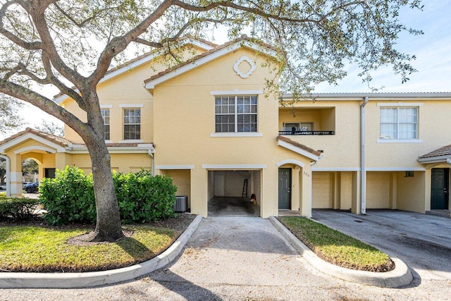 view of front of property with central AC and a garage