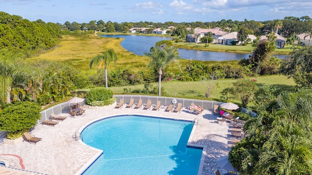 view of pool featuring a patio area and a water view