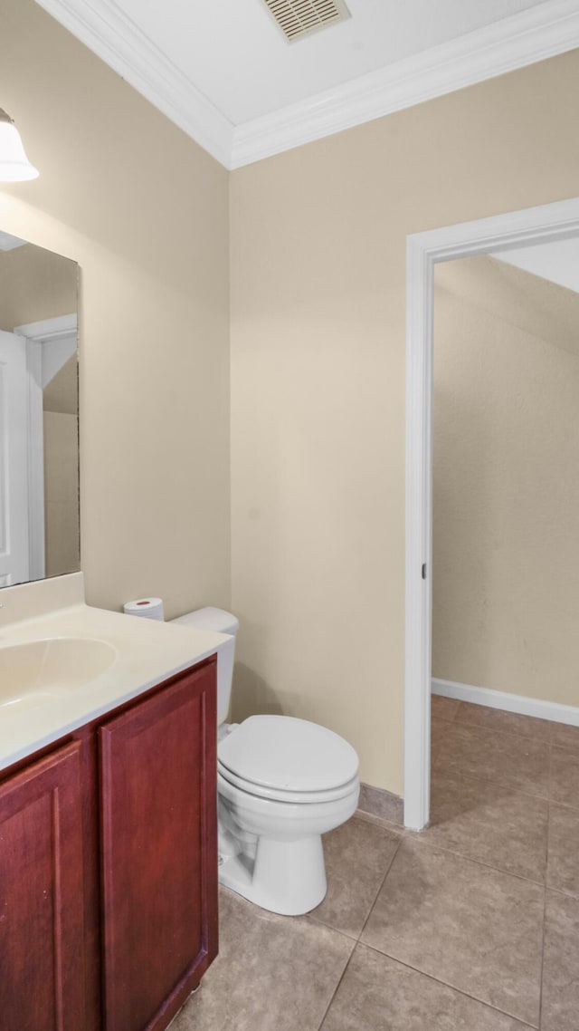 bathroom featuring vanity, tile patterned flooring, crown molding, and toilet