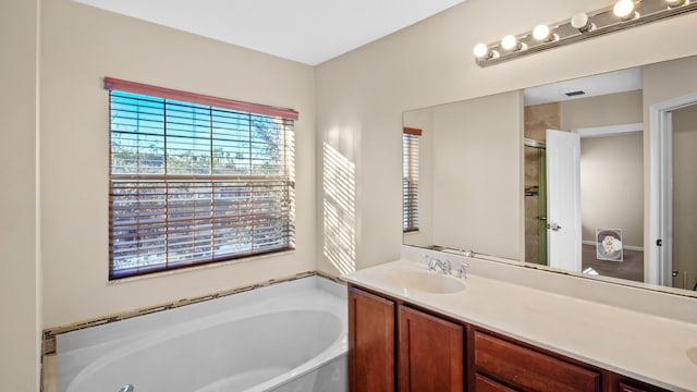 bathroom featuring vanity and a tub