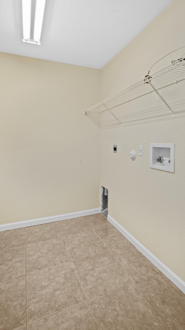 washroom with washer hookup, hookup for an electric dryer, and tile patterned floors