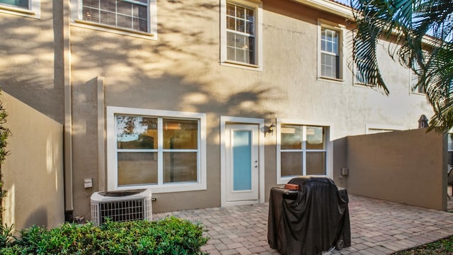 rear view of property with a patio area and central air condition unit