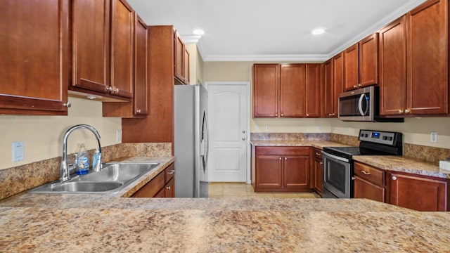 kitchen featuring sink, crown molding, light tile patterned floors, appliances with stainless steel finishes, and light stone countertops