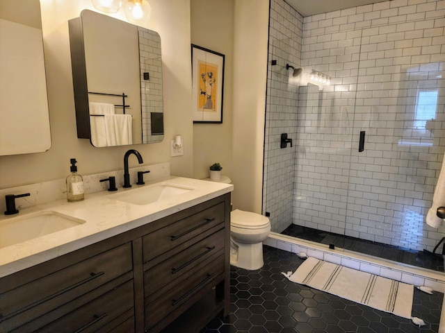 bathroom with tile patterned flooring, vanity, toilet, and walk in shower