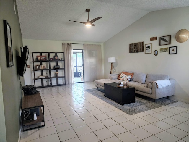 tiled living room with lofted ceiling, ceiling fan, and a textured ceiling