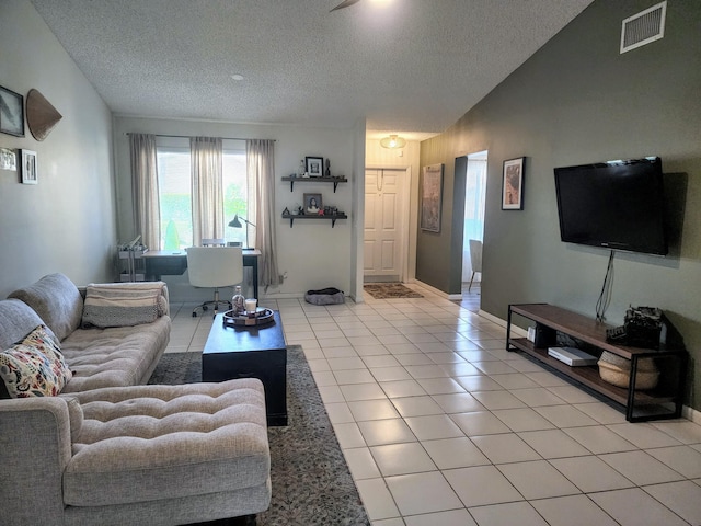 living room featuring a textured ceiling, vaulted ceiling, and light tile patterned flooring