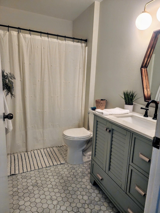 bathroom featuring tile patterned floors, vanity, and toilet