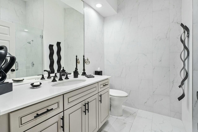 bathroom featuring a shower, vanity, tile walls, and toilet