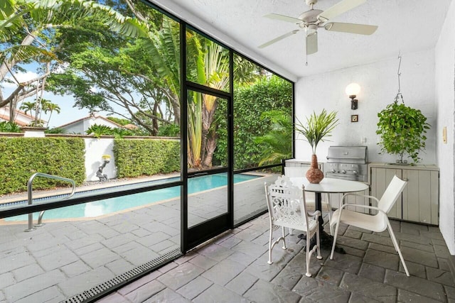 sunroom / solarium featuring ceiling fan and sink