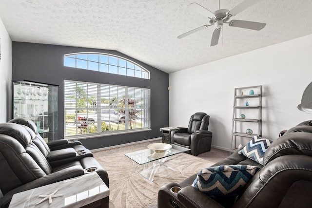 living room featuring a healthy amount of sunlight, a textured ceiling, and vaulted ceiling