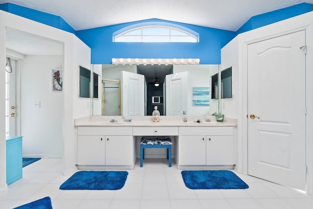 bathroom featuring tile patterned floors, an enclosed shower, vanity, a textured ceiling, and lofted ceiling