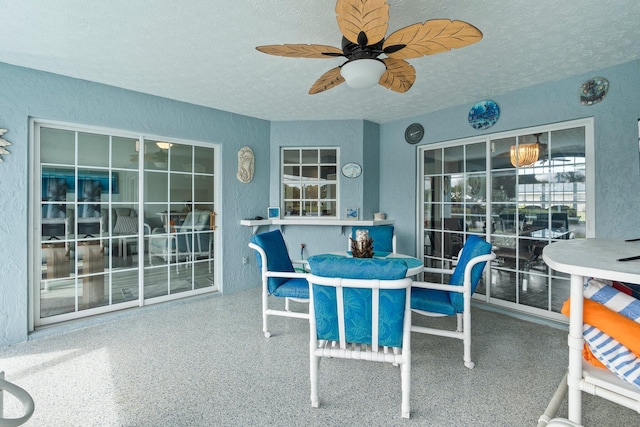 interior space with ceiling fan