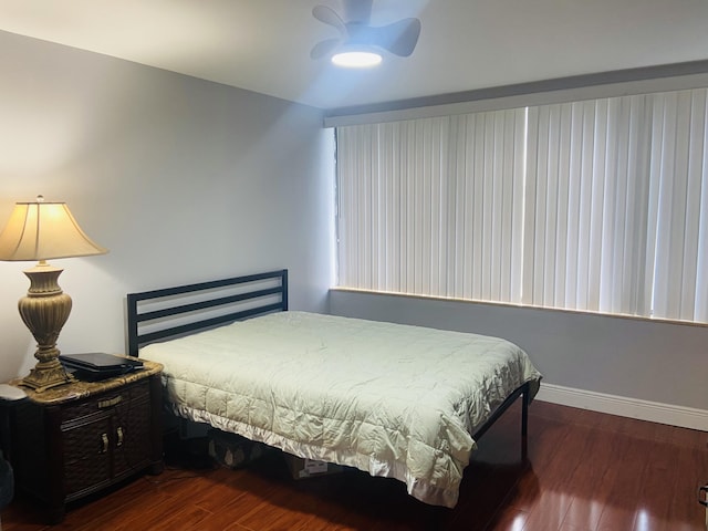 bedroom featuring ceiling fan and dark hardwood / wood-style floors