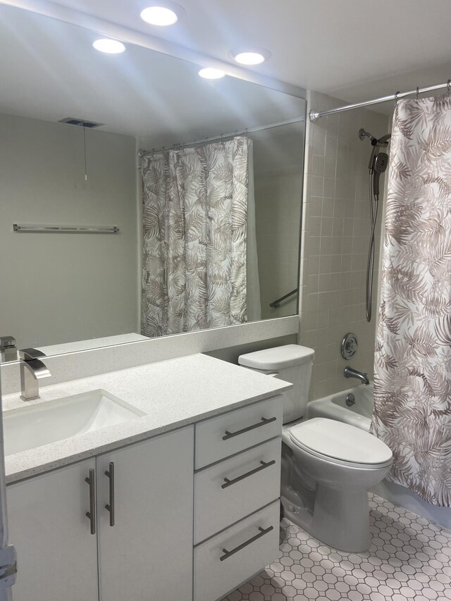 full bathroom with tile patterned flooring, vanity, toilet, and shower / tub combo with curtain