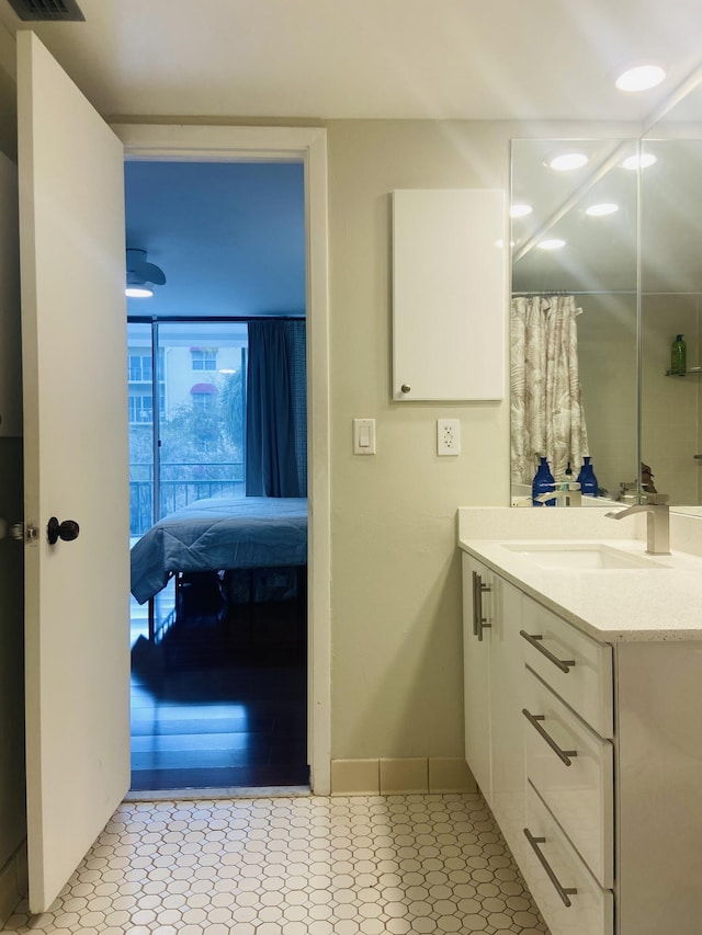 bathroom featuring tile patterned flooring and vanity