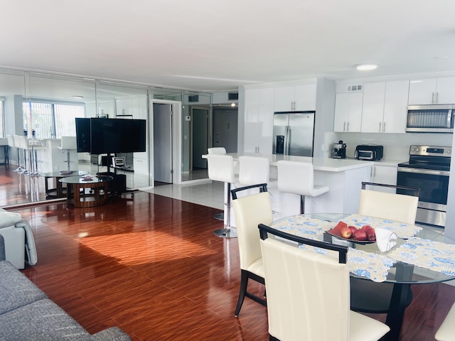 dining area featuring wood-type flooring