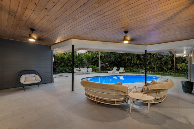 view of swimming pool featuring ceiling fan and a patio