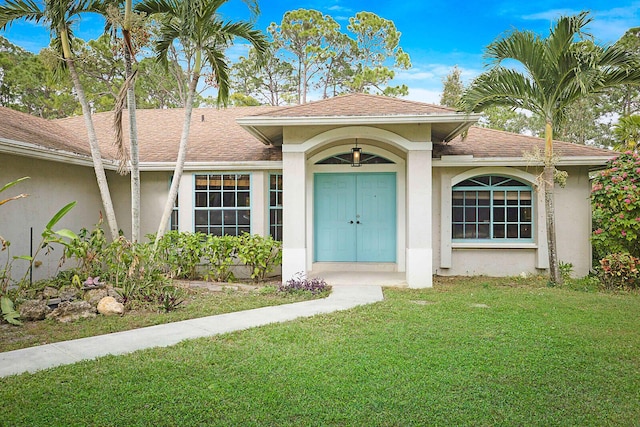 entrance to property featuring a lawn