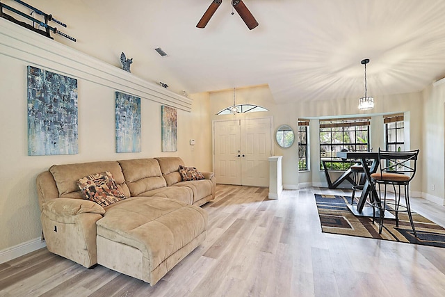 living room with ceiling fan and light hardwood / wood-style flooring