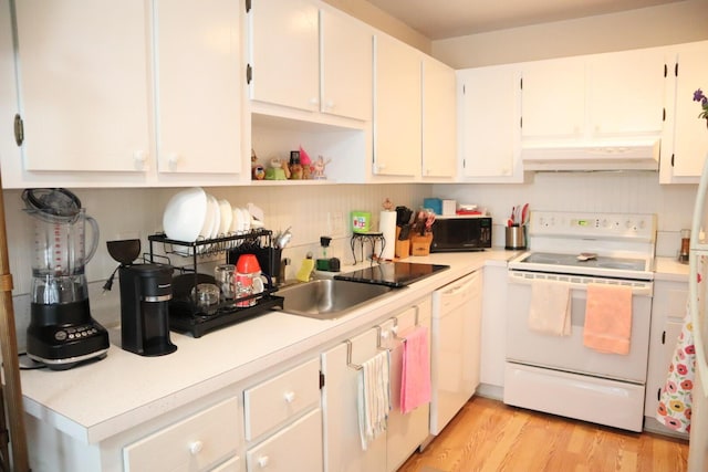 kitchen with sink, range hood, white appliances, white cabinets, and light wood-type flooring