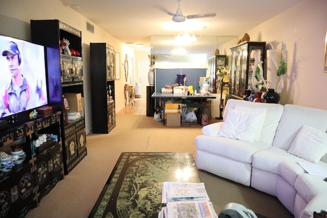 carpeted living room with ceiling fan