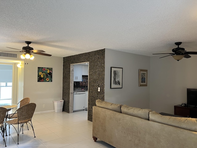 tiled living room featuring a textured ceiling and ceiling fan