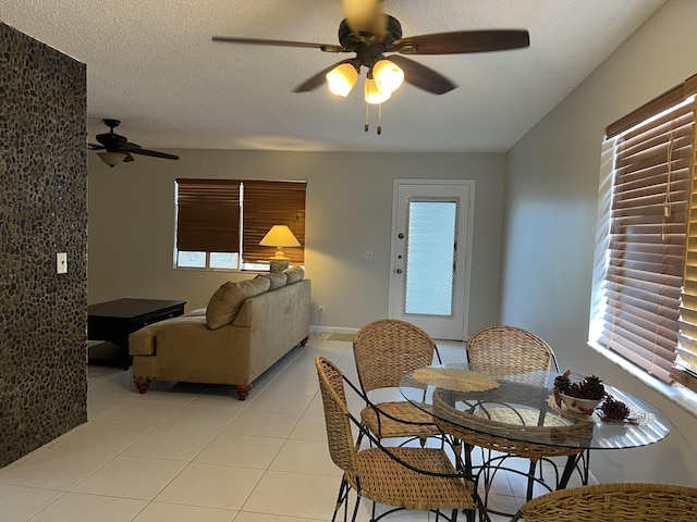 dining space featuring ceiling fan, light tile patterned flooring, and a wealth of natural light