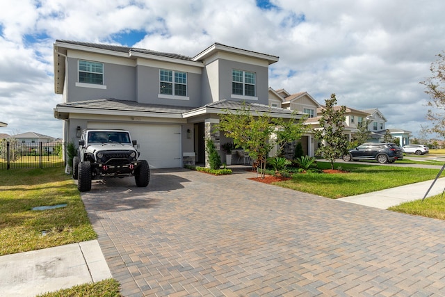 view of front facade featuring a garage and a front lawn