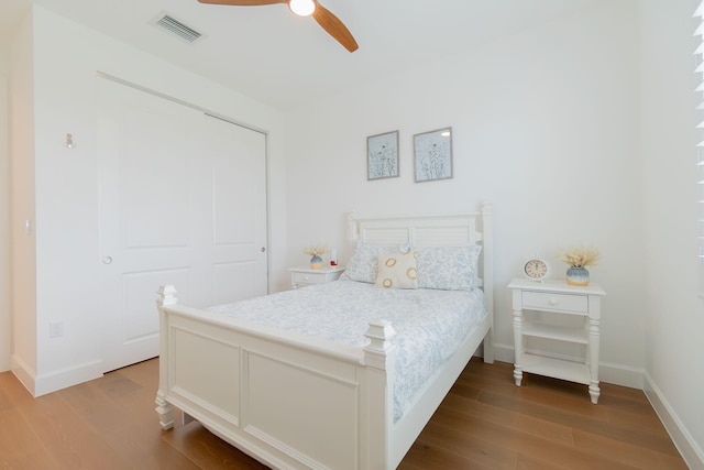 bedroom featuring ceiling fan, a closet, and light hardwood / wood-style floors