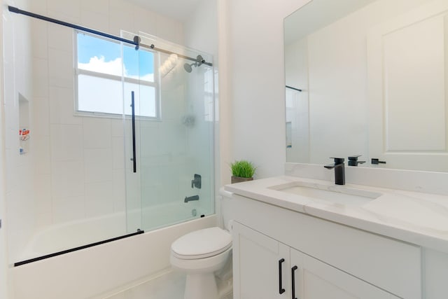 full bathroom featuring toilet, combined bath / shower with glass door, and vanity