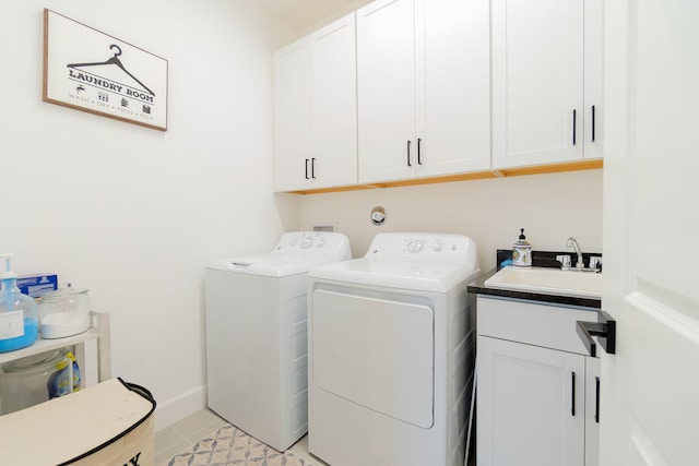 clothes washing area with washing machine and clothes dryer, sink, light tile patterned floors, and cabinets