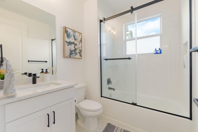 full bathroom featuring tile patterned flooring, toilet, vanity, and combined bath / shower with glass door