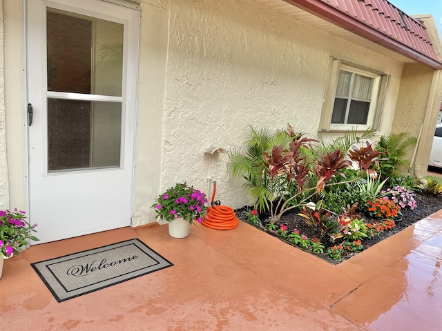 doorway to property featuring a patio area