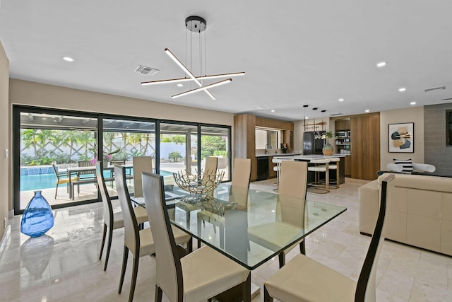 dining room with a notable chandelier and sink