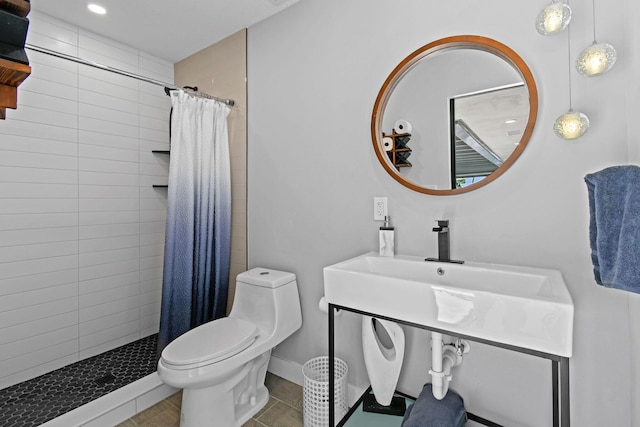 bathroom with tile patterned floors, vanity, toilet, and curtained shower