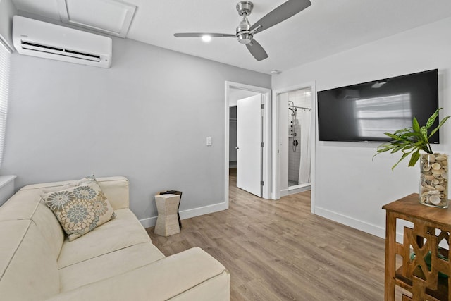 living room featuring light hardwood / wood-style floors, a wall mounted AC, and ceiling fan